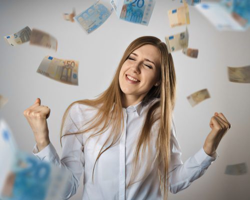 Rejoicing. Woman in white and falling Euro banknotes. Success, currency and lottery concept.